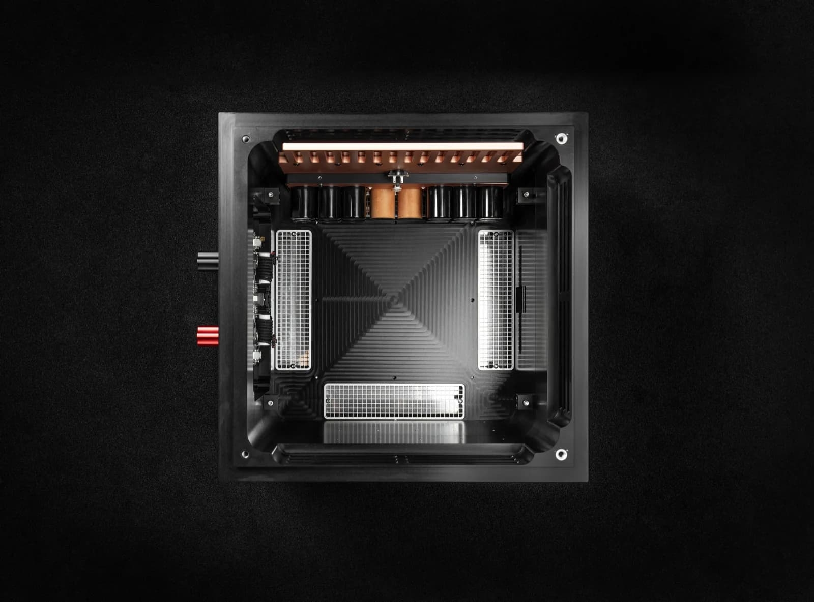 Top-down view into the UBICUBE chassis, its copper heat spreader above the capacitor bank