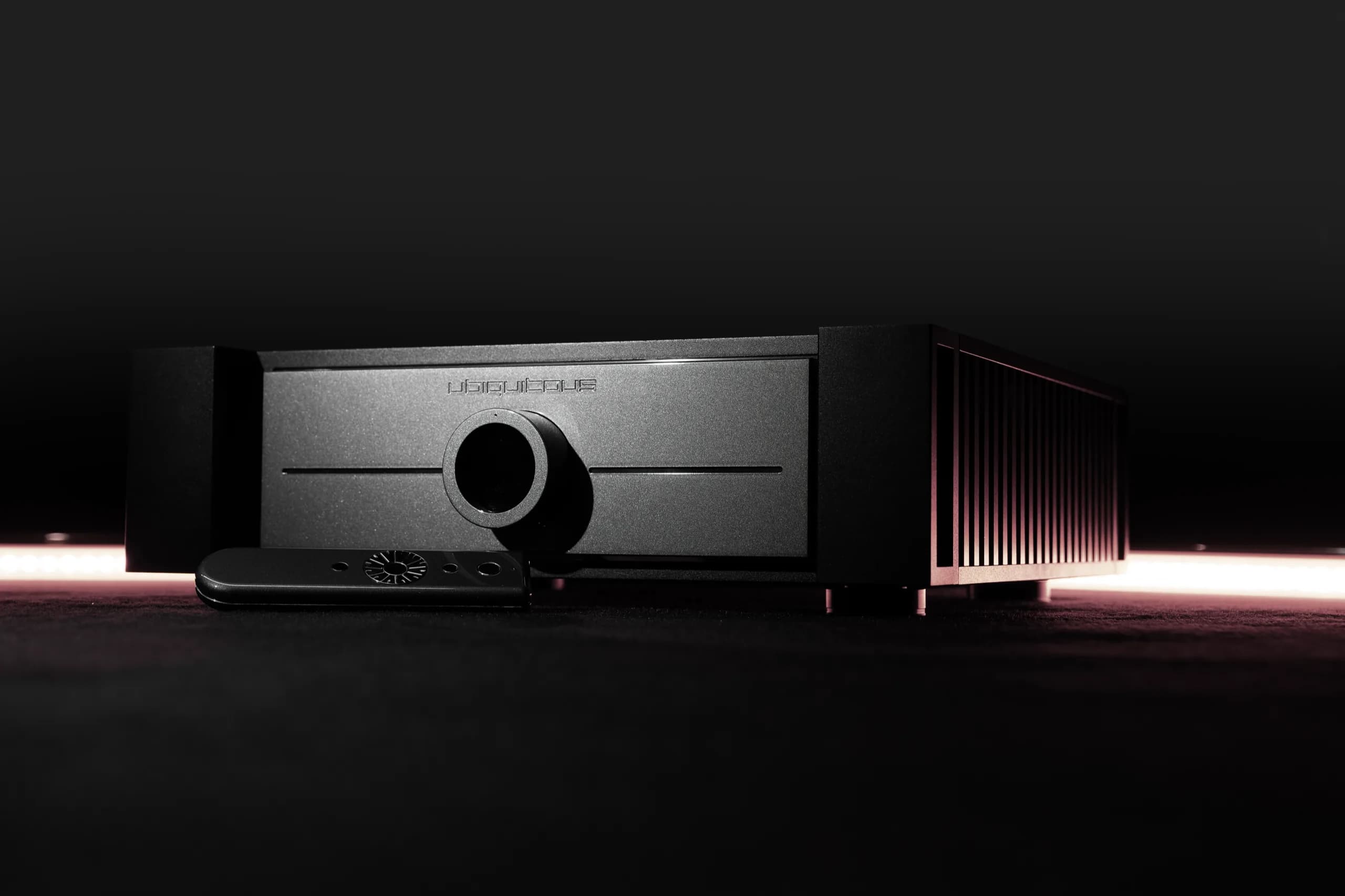 UBIQUITOUS 300B preamplifier with its remote control on a dark ground